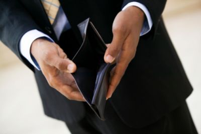 Close-up of businessman opening empty wallet with his hand
